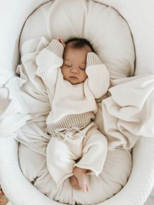 baby in white cot